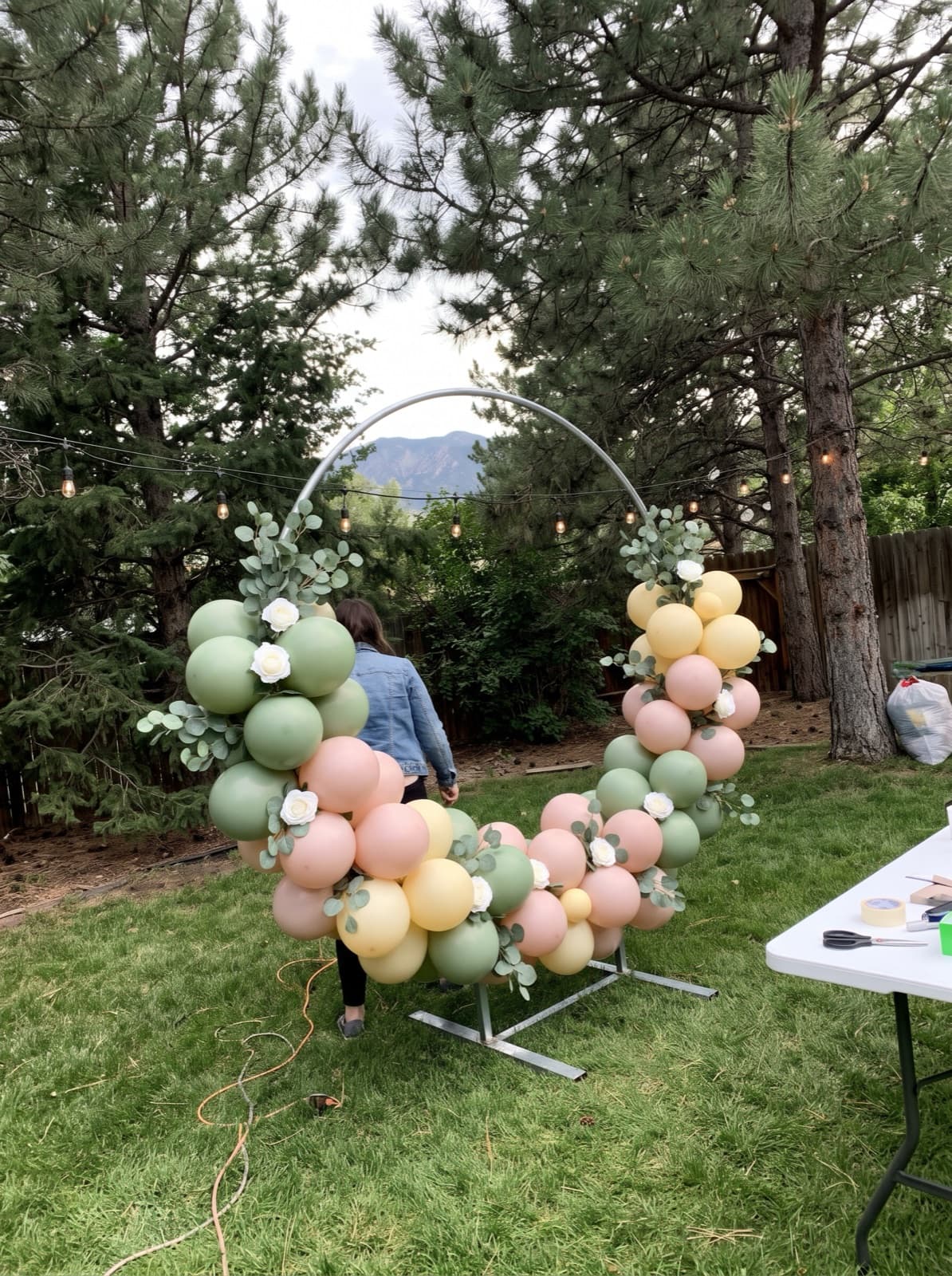 Balloon hoop backdrop with florals at a mountain-view venue