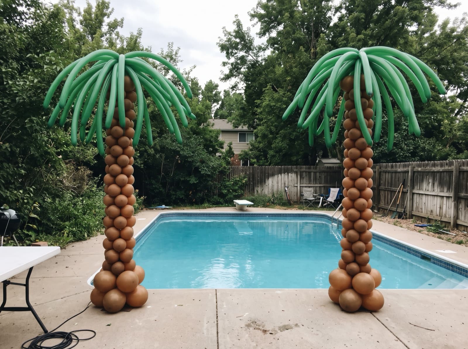 Balloon palm trees beside a backyard pool