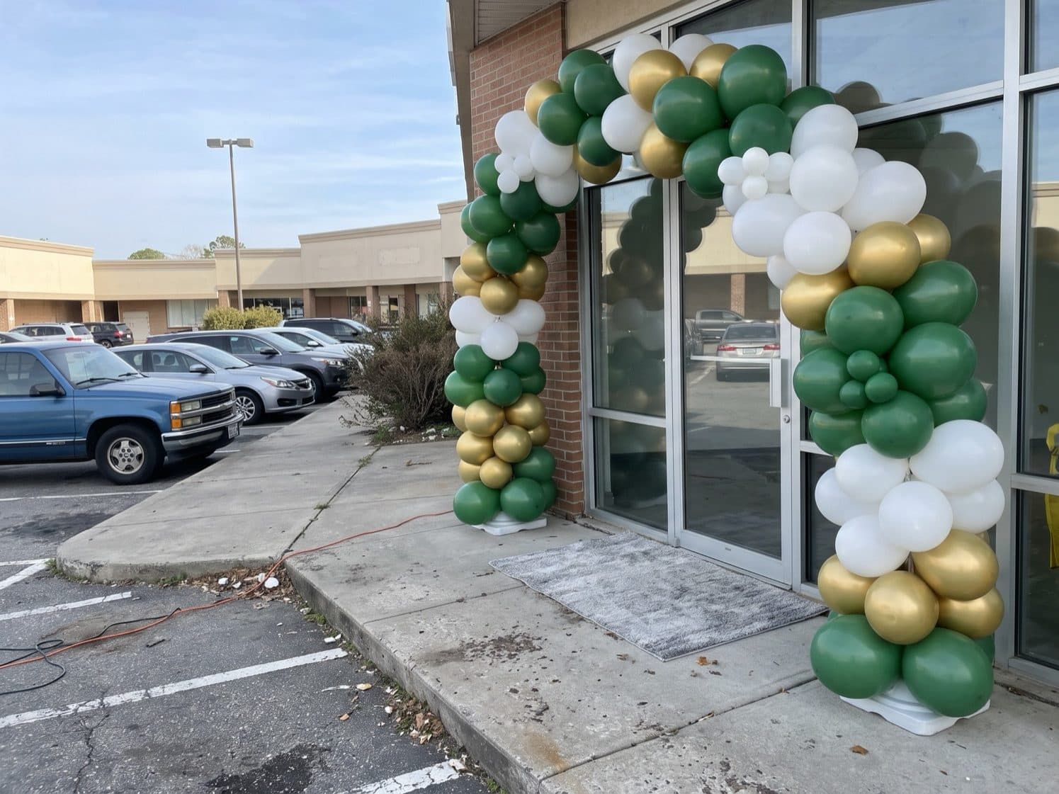 Giant balloon arch installation over a storefront