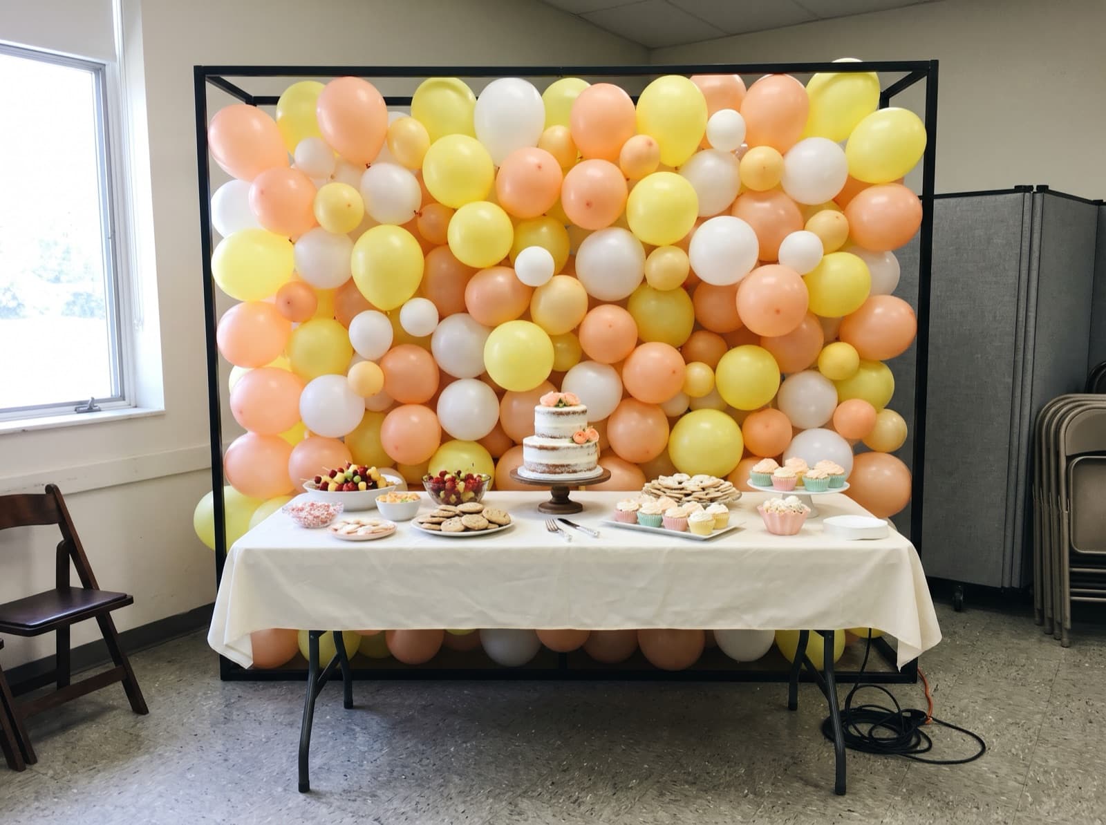 Square framed balloon wall in peach, lemon and white